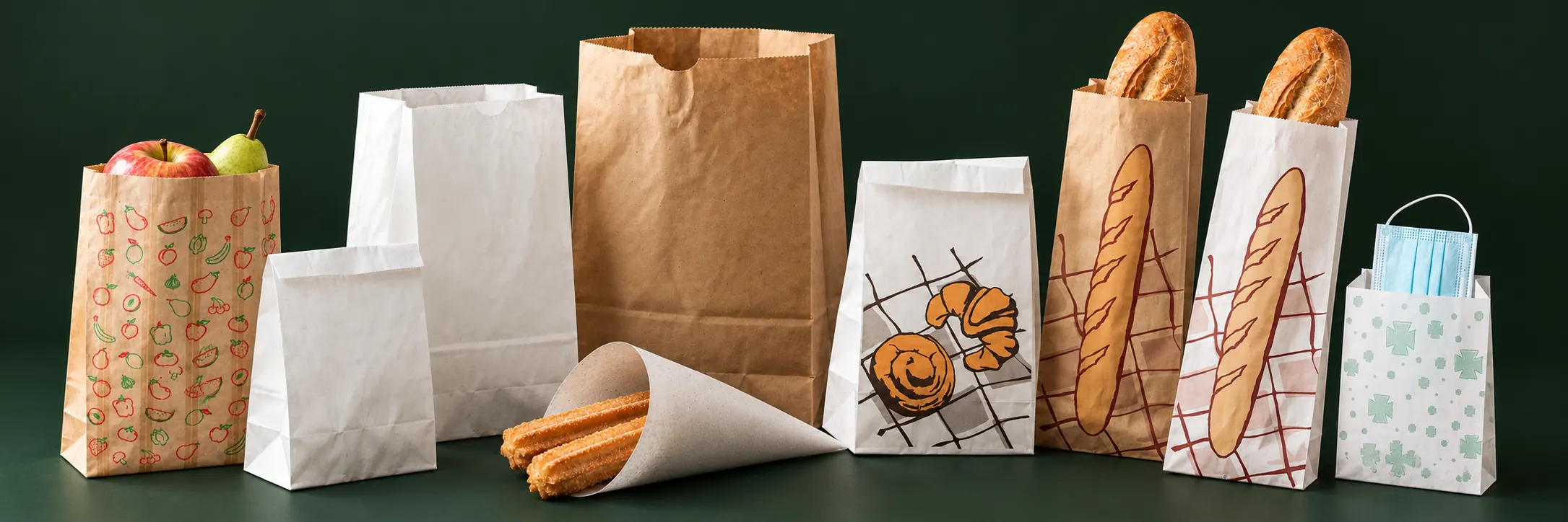 Las bolsas de Honest Bags juntas: frutería con fruta, americanas blancas y kraft, cucurucho con churros, bollería, barra en kraft y en blanco con su pan, y farmacia